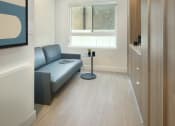 Thumbnail 10 of 16 - a small living room with a couch and a table