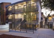 Thumbnail 2 of 16 - the facade of a building with stairs and a gate