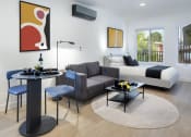 Thumbnail 5 of 16 - a living room with a couch and a table and a bed