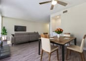 Thumbnail 7 of 11 - a living room and dining room with a table and chairs