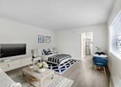 Thumbnail 2 of 83 - A modern bedroom with a large bed, a flat screen TV, and a blue chair.