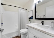 Thumbnail 4 of 83 - A white bathroom with a toilet, sink, and shower.