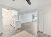 Thumbnail 20 of 91 - A kitchen with white cabinets and a ceiling fan.
