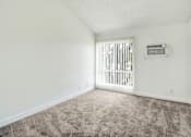 Thumbnail 24 of 91 - A room with a carpeted floor and a window with blinds.