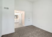 Thumbnail 26 of 91 - A room with white walls and a carpeted floor.