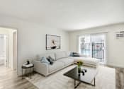 Thumbnail 2 of 95 - A living room with a white couch and a coffee table.