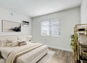 Thumbnail 4 of 95 - A bedroom with a large bed and a painting on the wall.