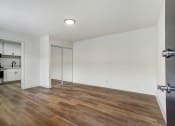 Thumbnail 68 of 83 - a bedroom with hardwood floors and white walls