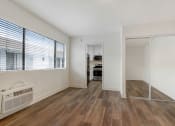 Thumbnail 66 of 83 - a bedroom with hardwood floors and a large window