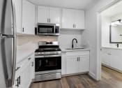 Thumbnail 33 of 83 - a kitchen with white cabinets and stainless steel appliances