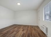 Thumbnail 69 of 83 - a bedroom with hardwood floors and white walls