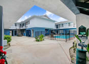 Thumbnail 56 of 83 - a building with a swimming pool in front of it