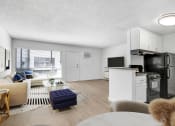 Thumbnail 19 of 95 - the living room of an apartment with a kitchen and a living room