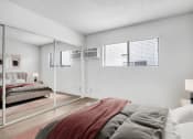 Thumbnail 23 of 95 - a bedroom with a large bed and a mirror