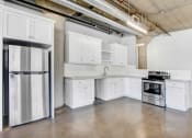 Thumbnail 88 of 92 - a kitchen with white cabinets and stainless steel appliances