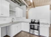 Thumbnail 89 of 92 - a kitchen with white cabinets and stainless steel appliances