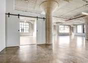 Thumbnail 86 of 92 - an empty room with white walls and concrete floors