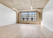 Thumbnail 87 of 92 - an empty room with wood floors and a large window