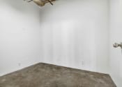 Thumbnail 92 of 92 - a white room with a concrete floor and white walls