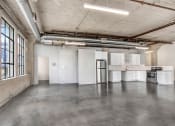 Thumbnail 80 of 92 - an empty room with white walls and concrete floors