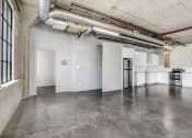 Thumbnail 79 of 92 - an empty room with white walls and concrete floors