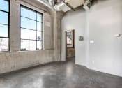 Thumbnail 72 of 92 - an empty room with a large window and concrete floors