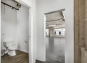 Thumbnail 83 of 92 - a bathroom with a white toilet and a wooden floor