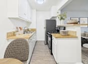 Thumbnail 26 of 55 - A kitchen with white cabinets and a granite countertop.