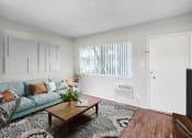 Thumbnail 5 of 28 - an open living room with a blue couch and a coffee table