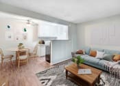 Thumbnail 1 of 28 - a living room with a couch and a table and a kitchen