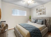 Thumbnail 7 of 28 - a bedroom with a bed and a ceiling fan