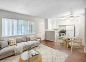 Thumbnail 9 of 28 - an open living room and kitchen with a couch and a table