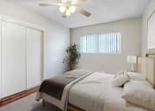 Thumbnail 11 of 28 - a bedroom with a large bed and a ceiling fan