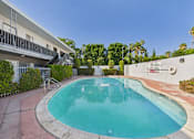 Thumbnail 54 of 55 - A small pool in a courtyard surrounded by a white building.