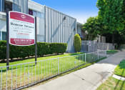 Thumbnail 27 of 28 - a fence in front of a building with a sign on it
