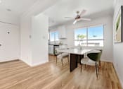 Thumbnail 12 of 28 - A room with a dining table and chairs.