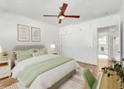Thumbnail 18 of 28 - A bedroom with a bed, a ceiling fan, and a green chair.