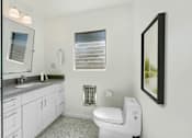 Thumbnail 17 of 28 - A white toilet is in a bathroom with a white sink and a window with blinds.