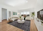 Thumbnail 13 of 28 - A living room with a white couch and a black and white rug.