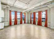 Thumbnail 32 of 92 - an empty room with red curtains in front of windows