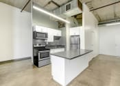 Thumbnail 28 of 92 - a kitchen with an island and stainless steel appliances