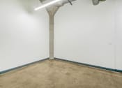 Thumbnail 34 of 92 - an empty room with a concrete floor and a pipe in the wall