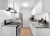 Thumbnail 32 of 65 - a renovated kitchen with white cabinets and stainless steel appliances