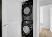 Thumbnail 7 of 69 - a washer and dryer stacked on top of each other in a laundry room