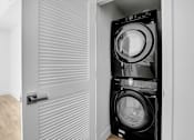 Thumbnail 15 of 69 - a laundry room with a washing machine and a dryer