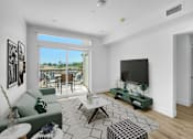 Thumbnail 20 of 69 - a living room with a couch and a tv and a balcony