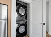 Thumbnail 46 of 69 - a small laundry room with a washer and a dryer