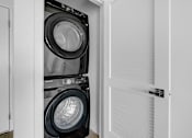 Thumbnail 32 of 69 - a laundry room with a washing machine and a dryer