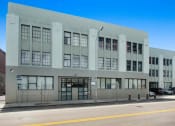Thumbnail 37 of 92 - a large white building with many windows on a street