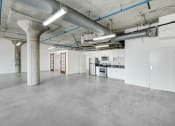 Thumbnail 41 of 92 - the interior of an empty warehouse with white walls and concrete floors